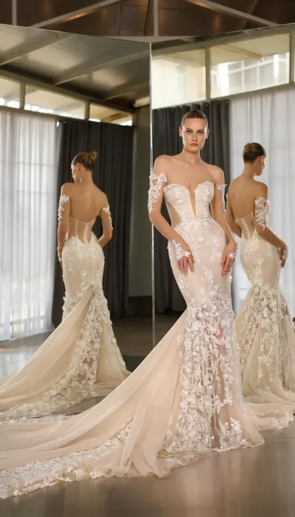 Elegant bridal gown with intricate floral lace, featuring a sweetheart neckline and flowing train. Reflections in the mirror showcase its stunning design.